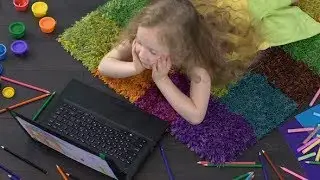 Small Blonde Girl Doing Homework On Computer, Modern Children Development | Stock Footage -