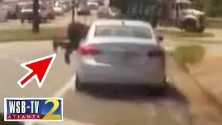Frightening! Cop dragged on highway, slammed into cars
