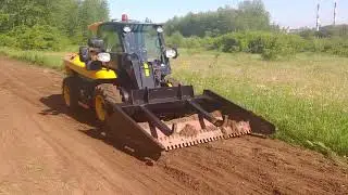 Leveling and widening of a dirt road by JCB loader