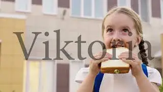 little girl with school backpack eats sandwich at recess school yard. children's snack school break