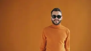 Portrait of Stylish Young Man Raising Trendy Sunglasses and Smiling | Stock Footage - Videohive