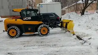 Snow removal from the parking lot by JCB loader with snow dump (part 2)