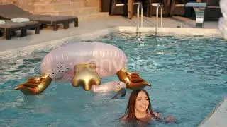 Happy Young Woman with Pink Flamingo Float in Swimming Pool | Stock Footage - Envato elements