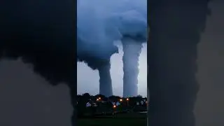 Double Waterspout behind the coastal town