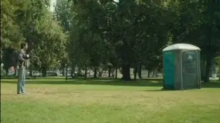man has diarrhea in a dirty portable toilet