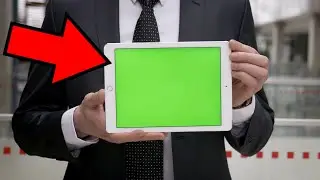Businessman in a suit holding a tablet with green screen - Chroma Key - No Copyright