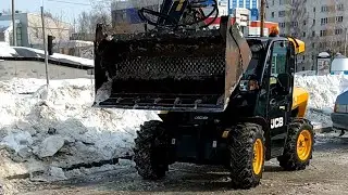 Removing ice from the parking lot with a JCB compact loader