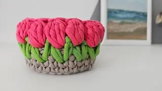 Basket of knitted yarn with tulips. Crochet basket made from leftover yarn.