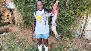 A village girl slaughtering rabbit//
