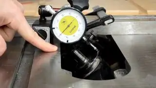 Grinding a table saw arbor to fix blade wobble.