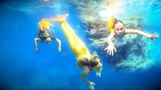 Mermaids swimming in the sea by Carla Underwater