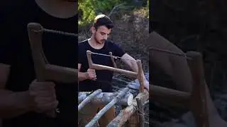 Building wood survival shelter in the forest.