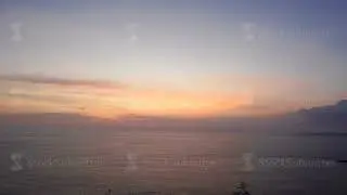 Slow motion meteorologist observing morning clouds at seaside.