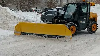 Snow removal from the parking lot by JCB loader with snow blade (part 1)