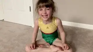 Little girl laughing while doing yoga.