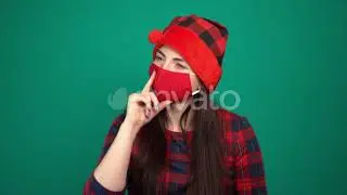 A Beautiful Woman Wearing Red Medical Mask and Christmas Hat Is Dreaming About Something | Stock...