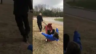 Guy accidentally dumps woman out the back of a little wagon!