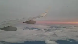 FREE STOCK FOOTAGE 4K! Airplane wing out window flying over sunset clouds