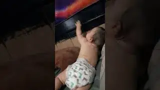 Enoch playing on the wall