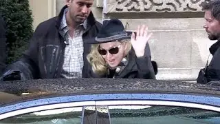Madonna leaving her hotel escorted py police to Grand Journal TV Show