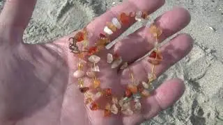 Metal detector search for jewelry on the beach video
