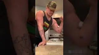 Guy tries to crack an egg with his bicep, farts, and drops the egg.