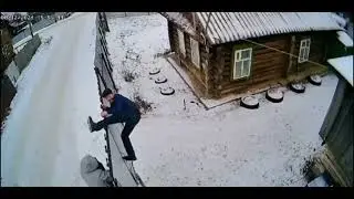 Drunk men struggle with a fence in Yanaule, Russia
