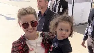 EXCLUSIVE : Amber Heard taking a cute baby kid in her arms as she arrives at Cannes airport