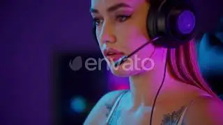 Tattooed Gamer Girl Chewing Bubble Gum and Sitting By the PC | Stock Footage - Envato elements