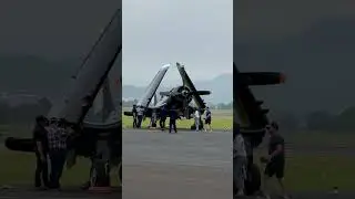 People are working together to turn the propeller on a small plane!
