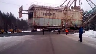 Go walking excavator by road. Walking dragline crossing road.