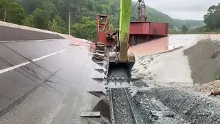 Large barge unloads 5200 tons of phosphate rock - Excavators and workers work together